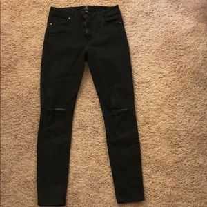 Distressed skinny jeans in a dark olive